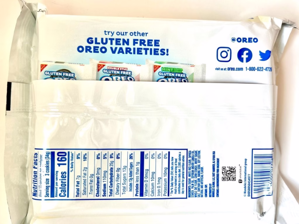 A white and blue package of OREO gluten free vanilla sandwich cookies is shown from the back, displaying nutritional information and promotional text.